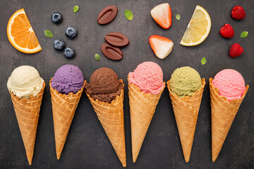 Fototapete - Flat lay ice cream cones collection on dark stone background . Blank crispy ice cream cone with copy space for sweets menu design.