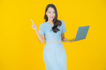 Wall Mural - Portrait beautiful young asian woman smile with computer laptop