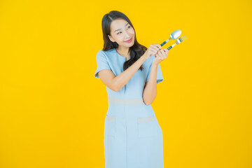 Wall Mural - Portrait beautiful young asian woman smile with spoon and fork