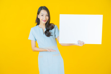 Wall Mural - Portrait beautiful young asian woman with empty white billboard