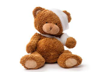 Wall Mural - medicine, healthcare and childhood concept - teddy bear toy with bandaged head and paw on white background