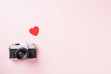 Valentines' Day Background. Vintage Retro Camera And Red Hearts Composition Greeting Card Love Valentines Day I Love Photography Concept On Pink Background With Copy Space. Top View From Above