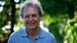 © Marco - Smiling senior man walking outside in green path, one happy older person