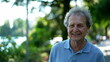 © Marco - Smiling senior man walking outside in green path, one happy older person