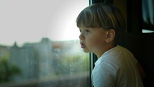 Little Boy Riding Train Looking Out Window
