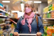 Senior Woman Shopping At Supermarket Pushing Cart, Wearing New Ffp2 Face Mask More Protective Against Omicron Variant Of Covid-19
