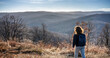 © olezzo - Young woman walking the hills and meadows on a spring sunny day