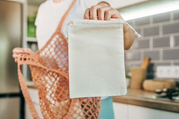 Wall Mural - Young woman holding reusable cotton produce bag for shopping