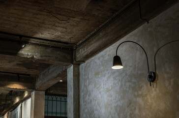 Wall Mural - Black lamp on grunge concrete cement wall in loft style. Selective focus.