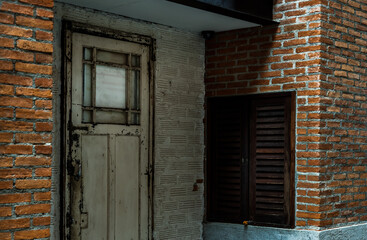 Wall Mural - White wooden door on the old red and white brick wall at vintage house. No focus, specifically.