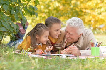 Sticker - Portrait of children and grandfather doing homework