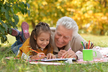 Sticker - Portrait of grandfather and his granddaughter drawing