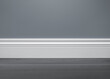 Close up of decorative, moulding white baseboard in empty room with copy space