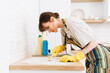 © Drobot Dean - White young woman in gloves cleaning table with brush