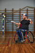 © Georgii - Young man in wheelchair playing tennis on court. Wheel Chair Tennis.