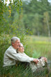 © aletia2011 - Portrait of happy senior couple sitting by pond