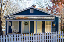 A Wood-frame, Tin Roofed Cottage With Twin Wooden Doors In Addieville, An Historic African American Mill Community In Athens, Georgia.