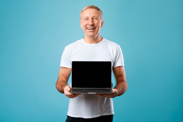 Poster - Happy mature man showing black empty pc screen