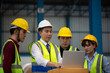 © Me studio - Warehouse worker meeting. Employee asian people using laptop in factory