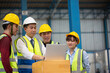 © Me studio - Warehouse worker meeting. Employee asian people using laptop in factory