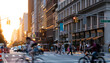 Crowded street scene with people, cars and bikes at the busy intersection of 23rd St and 5th Avenue in Manhattan New York City