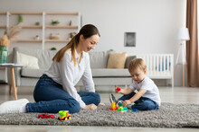 Baby Developmental Activities. Young Happy Mother Playing Educational Games With Her Adorable Toddler Son At Home