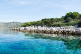 Fototapeta Do pokoju - Transparent clean and fresh sea water, isolated small islet in the Croatian archipelago