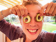 © Alexander - young woman making a funny joke by using cucumbers as eyeglasses