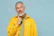 © ViDi Studio - Elderly wistful minded gray-haired mustache bearded man 50s wearing yellow shirt look aside on workspace area mock up isolated on plain pastel light blue background studio. People lifestyle concept.
