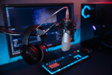 Professional Microphone With Headphones And Podcasts Equipment On The Background