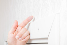 Young Adult Woman Finger Showing Dust From Top Of White Wooden Door Frame In Room. Closeup. Checking Cleanliness Quality.