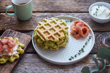 Sticker - Belgian avocado waffles with salmon. Side view, wooden background. Rustic. 