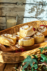 Sticker - Rose cinnamon rolls. Brioche. Top view, wooden background, cocoa, yeast buns, basket, milk. 