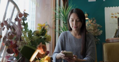 Canvas Print - Woman look at cellphone in coffee shop