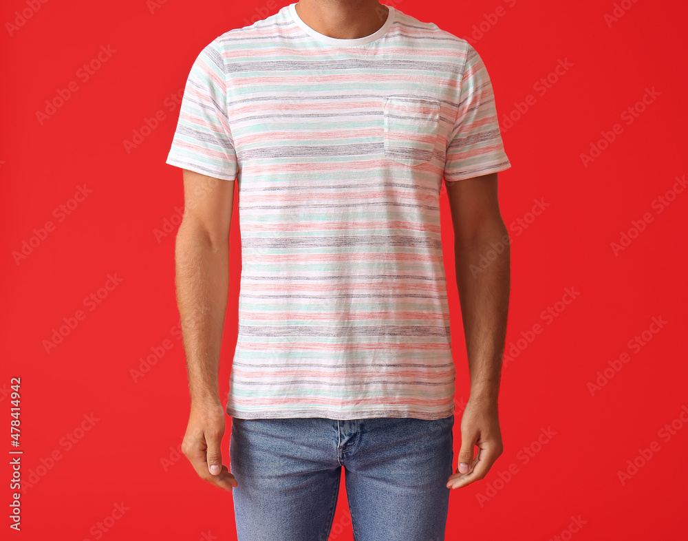 Handsome young man in stylish t-shirt on color background