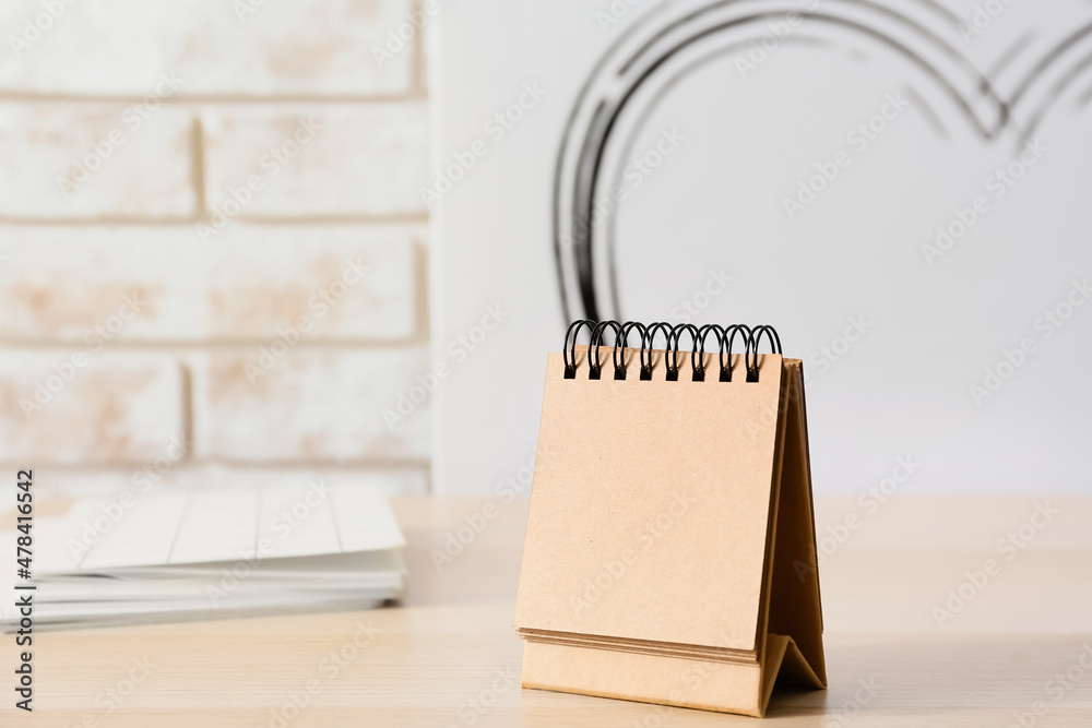 Blank craft calendar on wooden table
