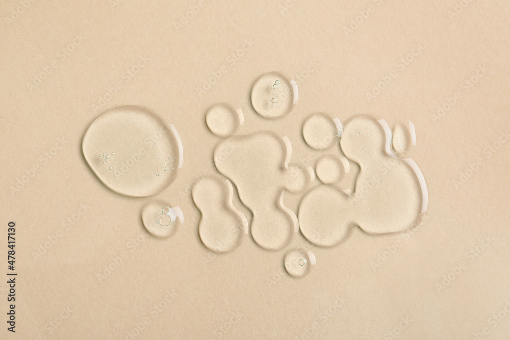 Drops of liquid transparent gel with bubbles on color background