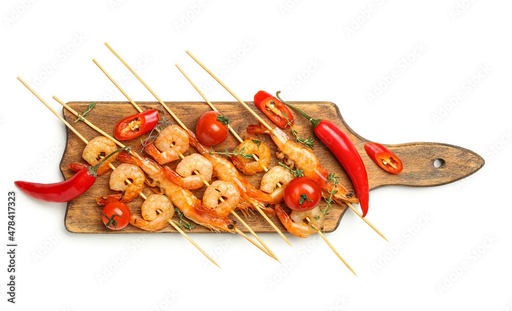 Wooden board with grilled shrimp skewers on white background