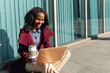 © Alberto - African college girl studies with her laptop while having a coffee in the street before an exam