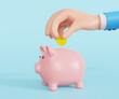 © tuiafalken - Hand putting coin into piggy bank on blue background, 3D rendering..