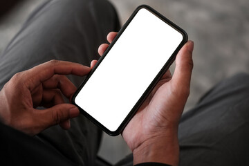 Wall Mural - close up view man holding mock up smart phone. blank screen for your advertising text.