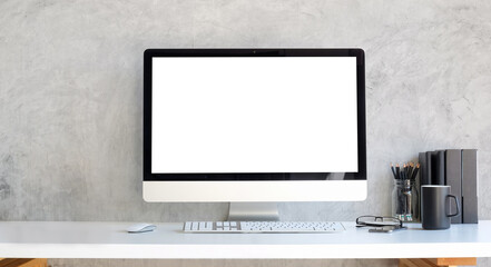 Wall Mural - Computer with blank white display and supplies on white table..