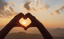 Silhouette Hands In Shape Of Love Heart Mountain Sunset Background.