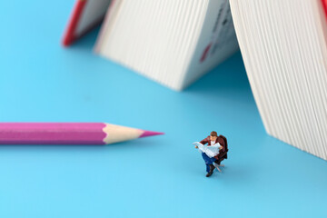 Poster - Reader on pencil next to miniature creative book