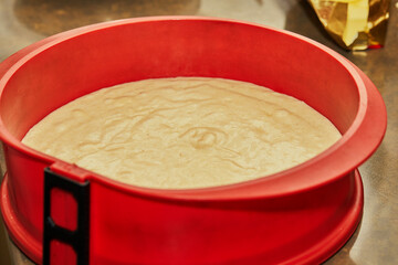 Wall Mural - Silicone mold with cake dough in the kitchen before baking