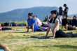 woman doing cobra pose, outdoor yoga group practice, exercise on mountain esplanade. Healthy, health, selective focus, blur