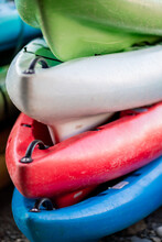 Close Up Shot Of Several Kayaks Stowed By The Sea Shore
