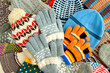 Clothing in the form of hats, mittens, gloves. Lots of hats, mittens, gloves for cold seasons. Hats, mittens and gloves are piled up as a background.