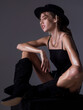 © Volodymyr - High fashion portrait. Young glamour woman model in hat wearing stylish fashion dress. Fashion model in studio.
