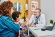 © Peakstock - Pediatrician consultation. Middle eastern boy with his mother while doctor's consultation with pediatrician. Child patient gives five to physician